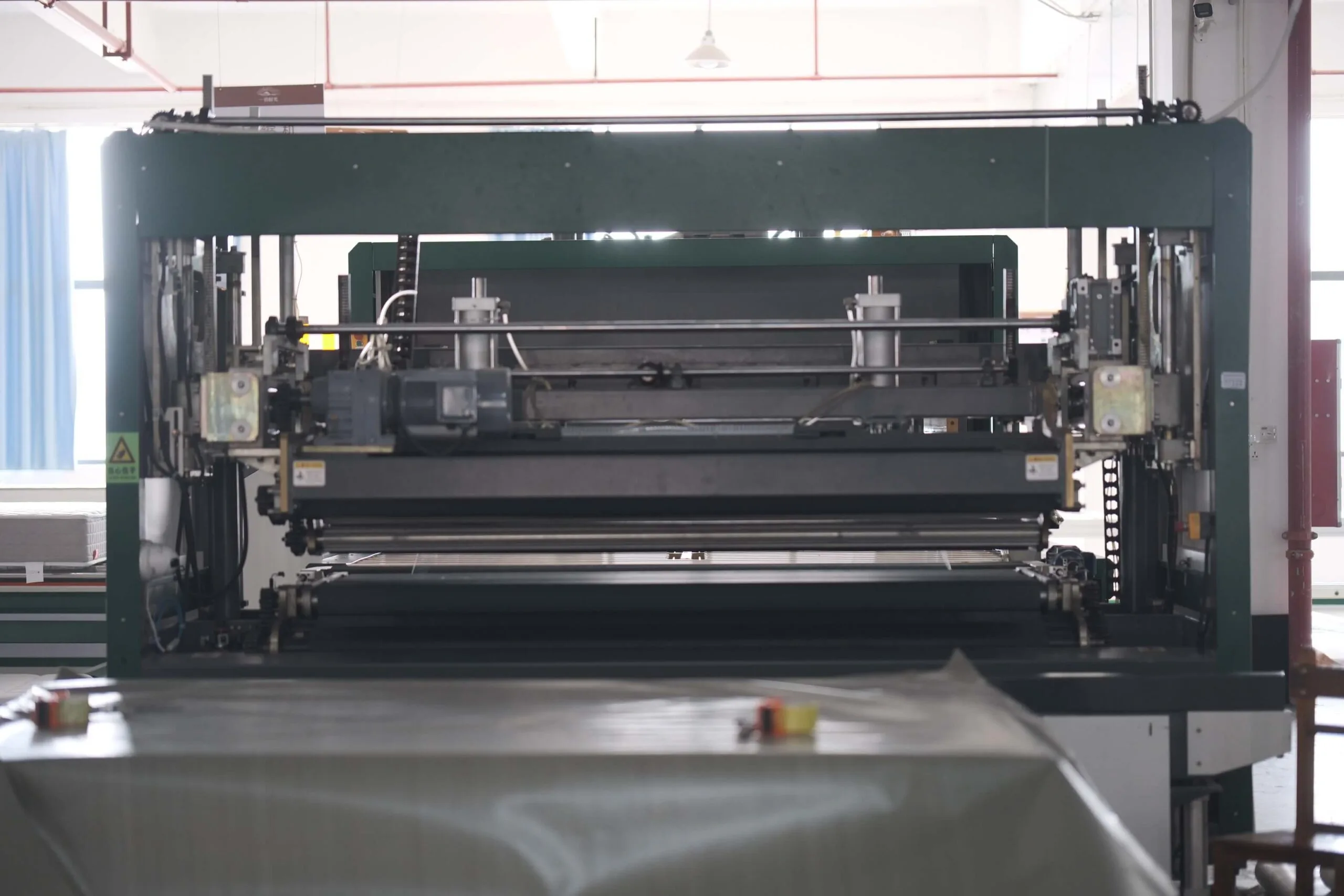 Mattress compression machine shown in idle state, used for vacuum packing