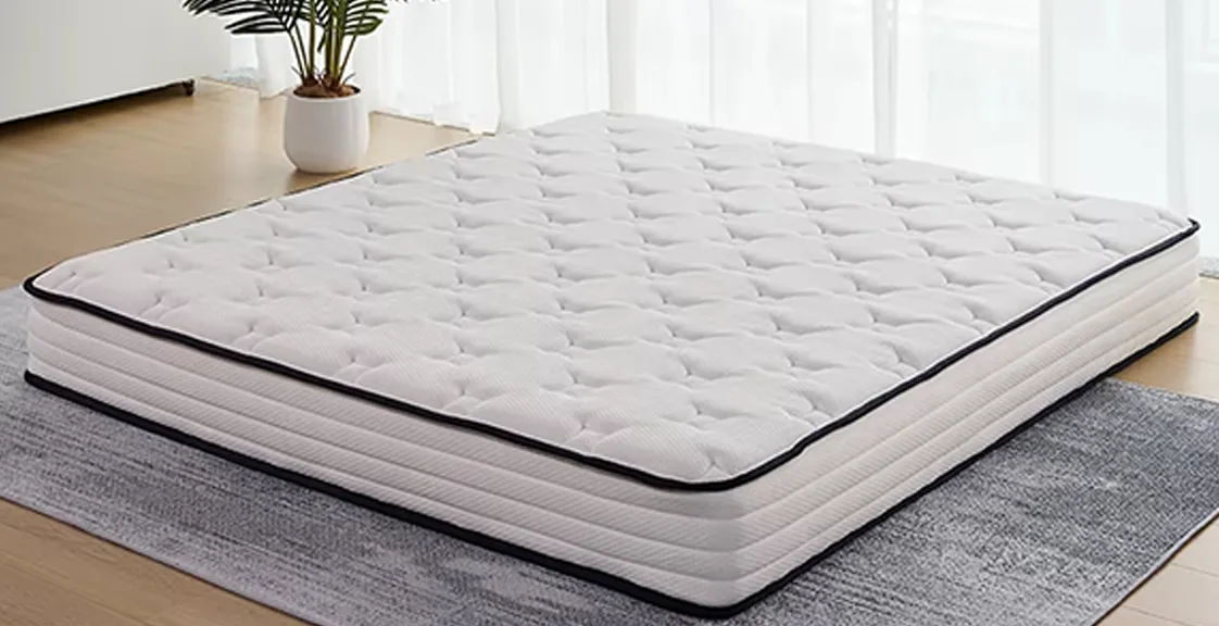 A white mixed-color mattress is on the floor
