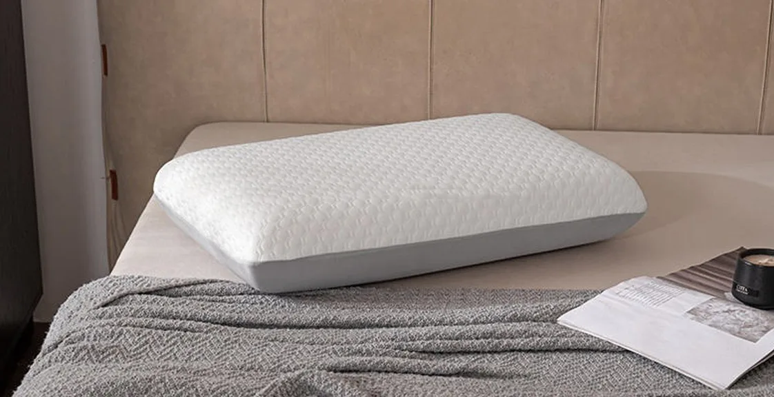 A white memory foam pillow on a bed