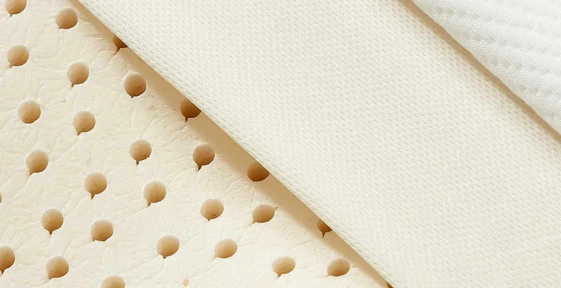 Close-up of the layered design of the Best Latex Mattress Topper, showing breathable latex with ventilation holes and soft fabric cover