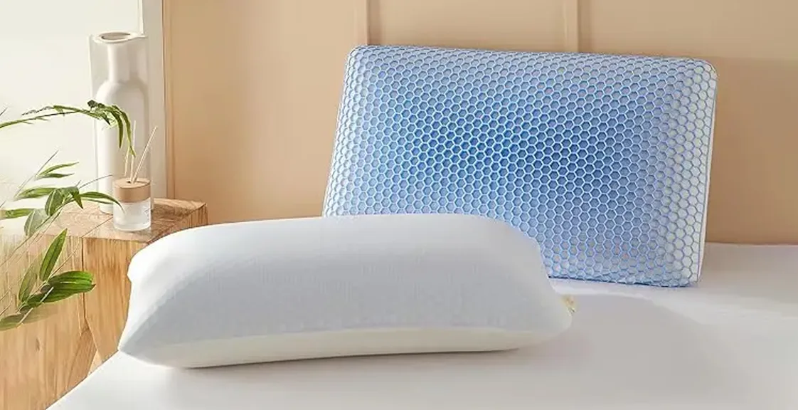 Two extra-firm memory foam pillows with cooling gel covers placed on a bed near a window.