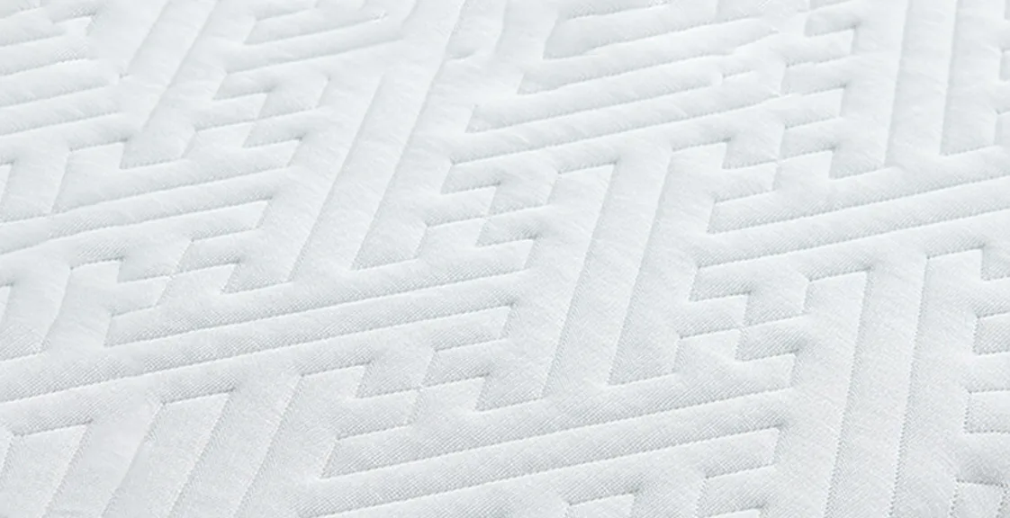 Close-up of a memory foam pillow cover with a geometric quilted texture pattern, showing the soft and breathable fabric surface