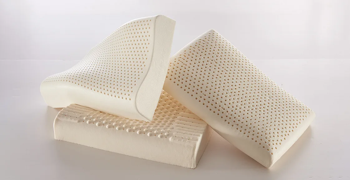 Three latex pillows with different internal structures and surface designs, showing variations in firmness and support