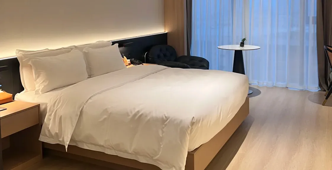 Luxury hotel room featuring a medium-firm pocket spring mattress designed for commercial hospitality use