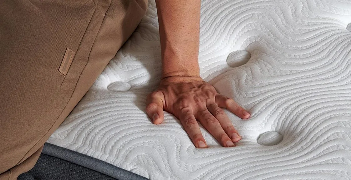 Person sitting on the spring mattress