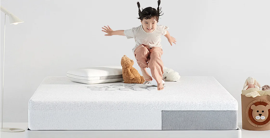 Child jumping on a children mattress with support