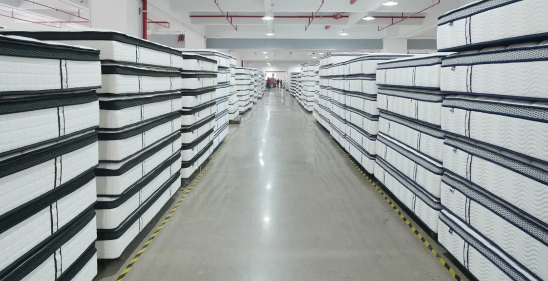 Stacked mattresses in warehouse ready for export