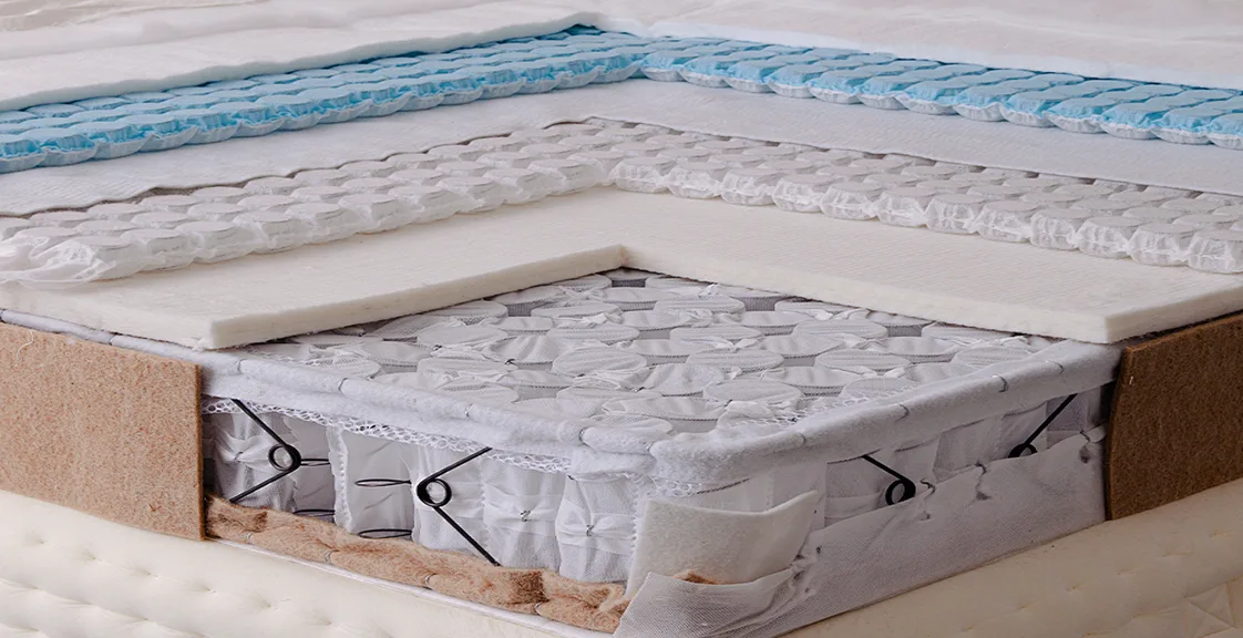 Close-up of a hybrid mattress with pocket springs and foam.