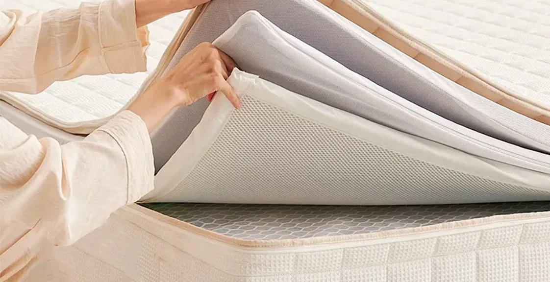 Mattress layers bonded with low VOC adhesives