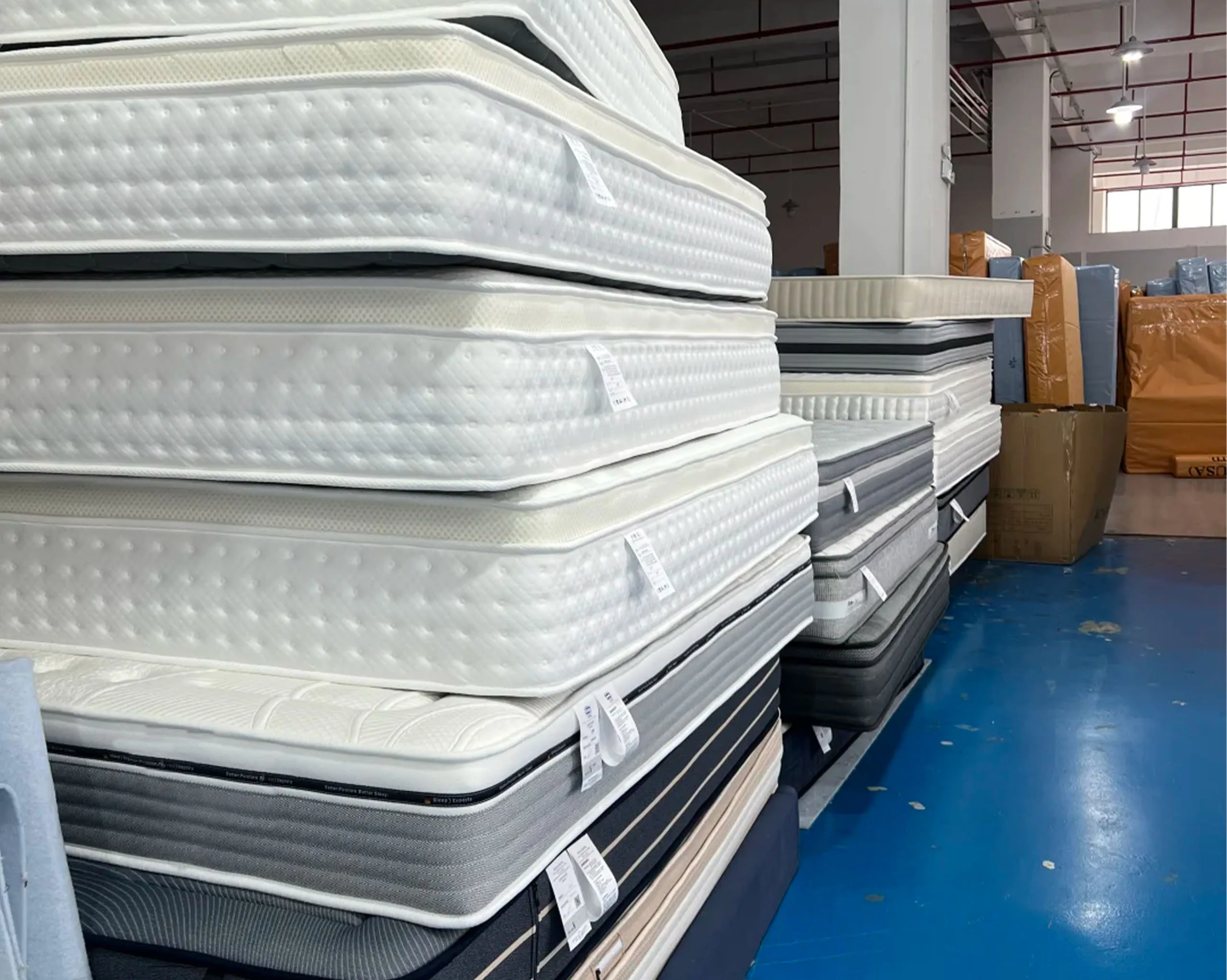 Large quantity of finished mattresses neatly stacked in warehouse, demonstrating stable production capacity and fast delivery capability