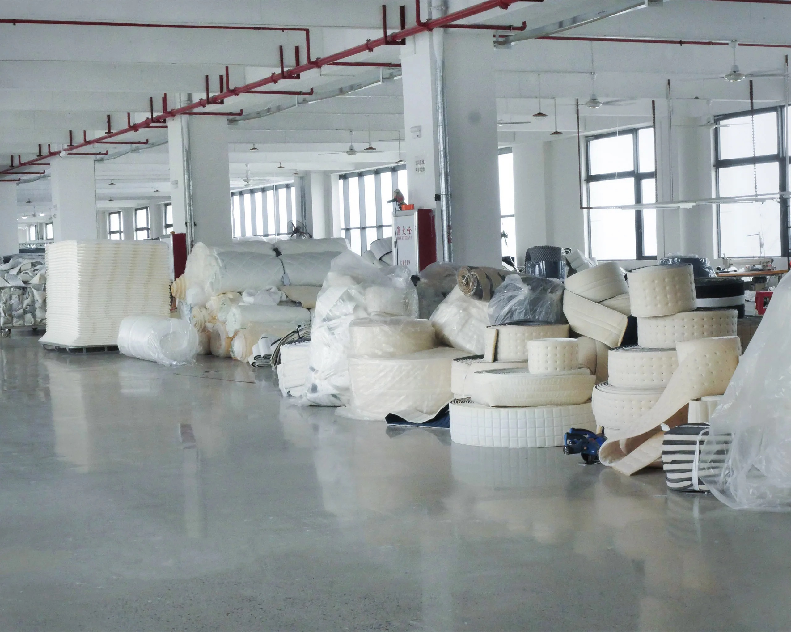 Side panel fabrics and auxiliary materials neatly stored in factory warehouse, ensuring organized management and stable supply for production