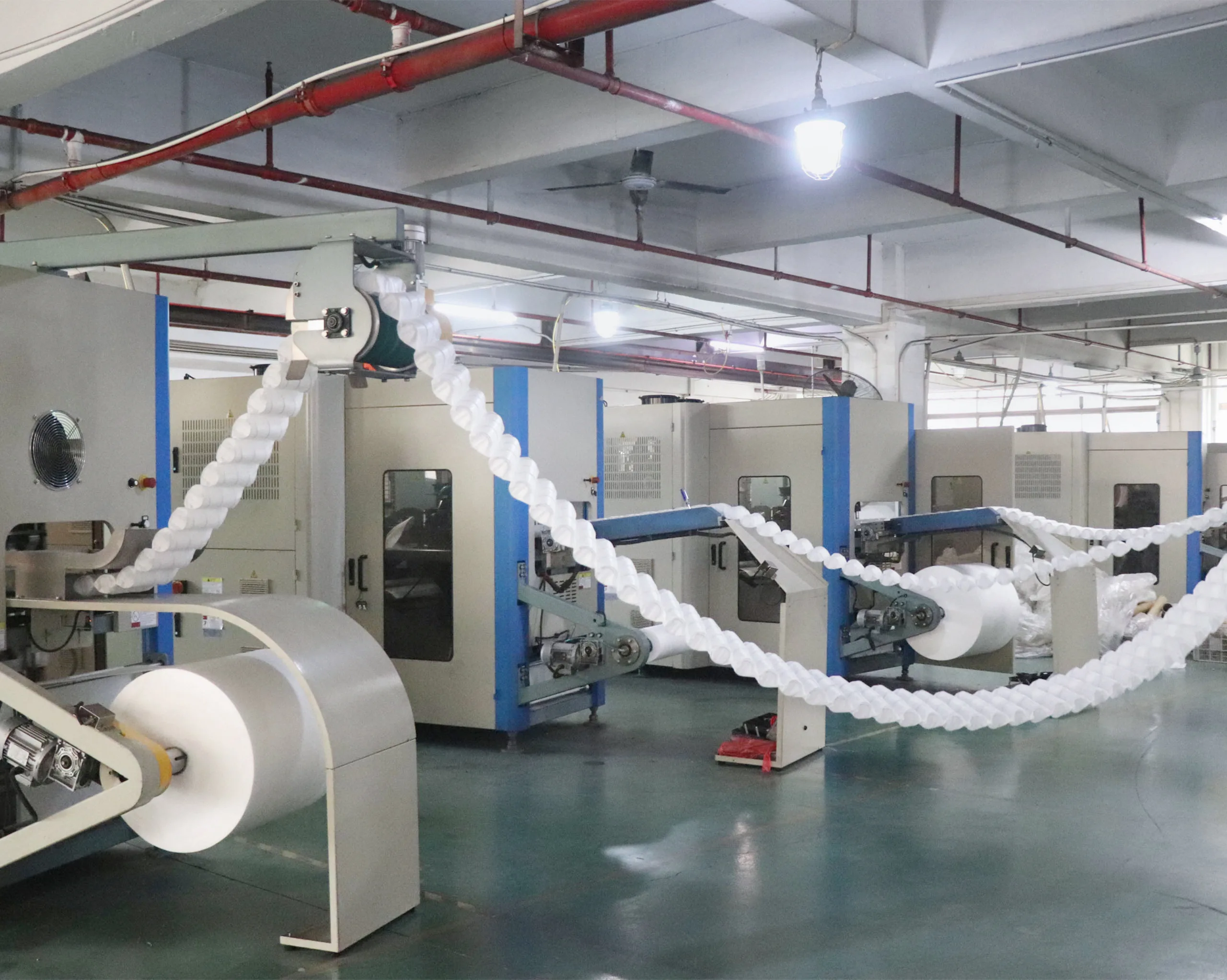 Automated machine producing pocket spring units, ensuring structural stability and consistent support performance of mattresses