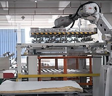 Robotic arm for automated mattress production